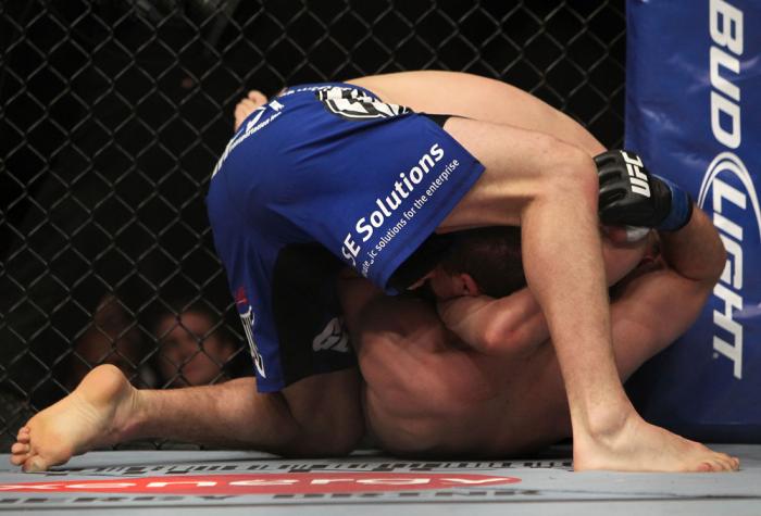 CHICAGO, IL - JANUARY 28: Evan Dunham (blue shorts) attempts a guillotine choke submission against Nik Lentz during the UFC on FOX event at United Center on January 28, 2012 in Chicago, Illinois. (Photo by Josh Hedges/Zuffa LLC/Zuffa LLC via Getty Image