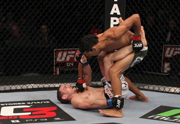 CHICAGO, IL - JANUARY 28: (R-L) Charles Oliveira punches Eric Wisely during the UFC on FOX event at United Center on January 28, 2012 in Chicago, Illinois. (Photo by Nick Laham/Zuffa LLC/Zuffa LLC via Getty Images) *** Local Caption *** Eric Wisely; Cha