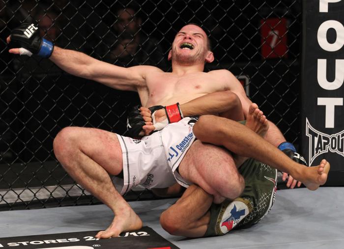 CHICAGO, IL - JANUARY 28: Eric Wisely grimaces in pain as he is caught in a leg lock submission by Charles Oliveira during the UFC on FOX event at United Center on January 28, 2012 in Chicago, Illinois. (Photo by Nick Laham/Zuffa LLC/Zuffa LLC via Getty