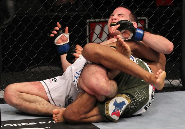 CHICAGO, IL - JANUARY 28: Eric Wisely grimaces in pain as he is caught in a leg lock submission by Charles Oliveira during the UFC on FOX event at United Center on January 28, 2012 in Chicago, Illinois. (Photo by Nick Laham/Zuffa LLC/Zuffa LLC via Getty