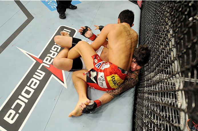 BARUERI, BRAZIL - OCTOBER 9: Erick Silva lies pinned underneath Dong Hyun Kim (red shorts) in their welterweight bout during the UFC Fight Night event at the Ginasio Jose Correa on October 9, 2013 in Barueri, Sao Paulo, Brazil. (Photo by Jeff Bottari/Zuf