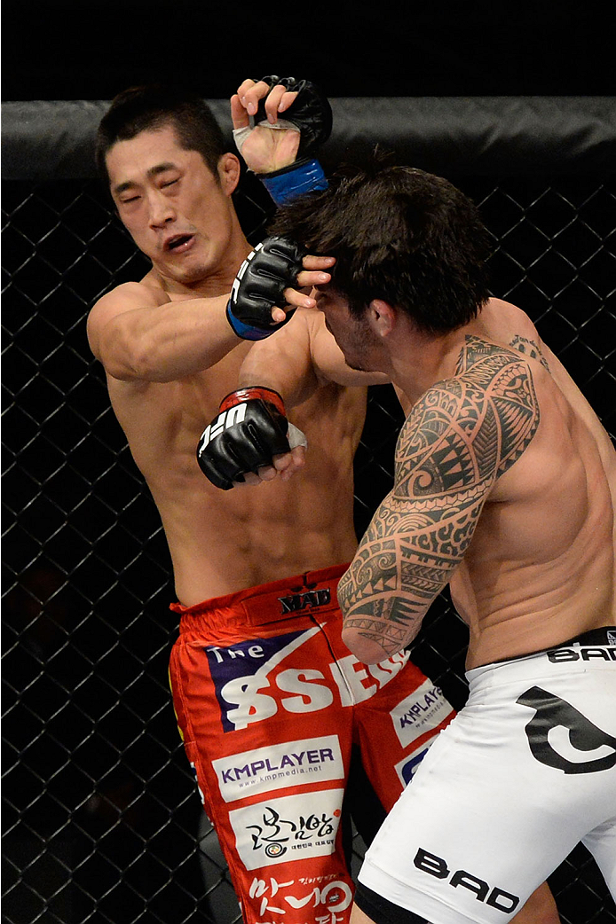 BARUERI, BRAZIL - OCTOBER 9: (L-R) Dong Hyun Kim gets punched by Erick Silva in their welterweight bout during the UFC Fight Night event at the Ginasio Jose Correa on October 9, 2013 in Barueri, Sao Paulo, Brazil. (Photo by Jeff Bottari/Zuffa LLC/Zuffa L