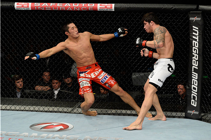 BARUERI, BRAZIL - OCTOBER 9: (L-R) Dong Hyun Kim falls to the ground after getting punched by Erick Silva in their welterweight bout during the UFC Fight Night event at the Ginasio Jose Correa on October 9, 2013 in Barueri, Sao Paulo, Brazil. (Photo by J