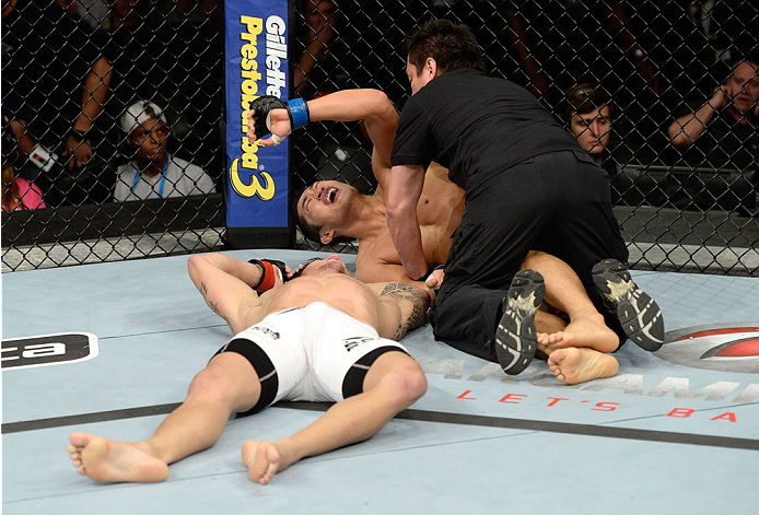 BARUERI, BRAZIL - OCTOBER 9: Referee Mario Yamasaki (R) stops the fight between Dong Hyun Kim and Erick Silva (white shorts) after Silva was knocked out in their welterweight bout during the UFC Fight Night event at the Ginasio Jose Correa on October 9,