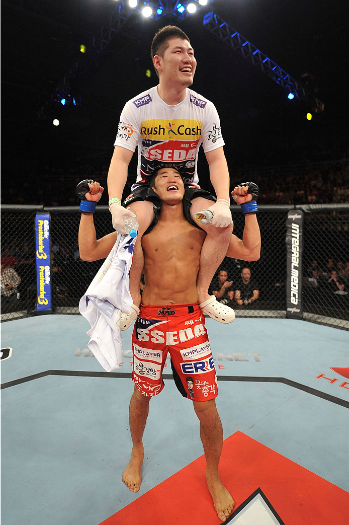 BARUERI, BRAZIL - OCTOBER 9: Dong Hyun Kim (red shorts) celebrates with his corner after defeating Erick Silva (not pictured) in their welterweight bout during the UFC Fight Night event at the Ginasio Jose Correa on October 9, 2013 in Barueri, Sao Paulo,