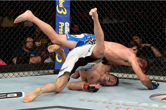 BARUERI, BRAZIL - OCTOBER 9: Jake Shields (blue shorts) jumps on Demian Maia (white shorts) in their welterweight bout during the UFC Fight Night event at the Ginasio Jose Correa on October 9, 2013 in Barueri, Sao Paulo, Brazil. (Photo by Jeff Bottari/Zu