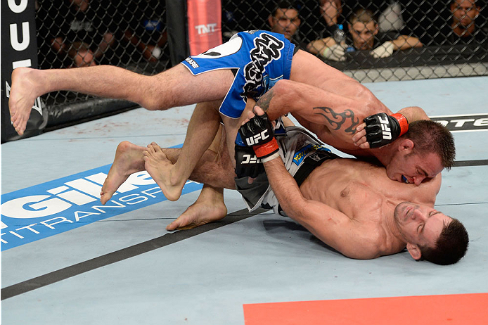 BARUERI, BRAZIL - OCTOBER 9: Jake Shields (blue shorts) jumps on Demian Maia (white shorts) in their welterweight bout during the UFC Fight Night event at the Ginasio Jose Correa on October 9, 2013 in Barueri, Sao Paulo, Brazil. (Photo by Jeff Bottari/Zu