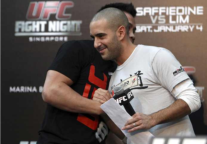 SINGAPORE - JANUARY 03: (L and R) Cung Le and Jon Anik embrace during the UFC Fight Night Singapore Q&A at the Shoppes at Marina Bay Sands on January 3, 2014 in Singapore. (Photo by Mitch Viquez/Zuffa LLC/Zuffa LLC via Getty Images)