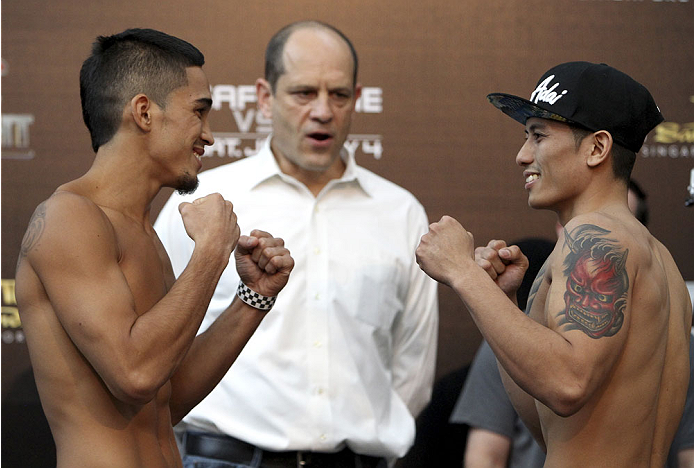 SINGAPORE - JANUARY 03: (L and R) Dustin Kimura and Jon Delos Reyes face off during the UFC Fight Night Singapore Weigh-in at the Shoppes at Marina Bay Sands on January 3, 2014 in Singapore. (Photo by Mitch Viquez/Zuffa LLC/Zuffa LLC via Getty Images)
