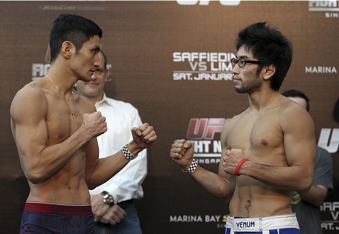 SINGAPORE - JANUARY 03: (L and R) Kang Kyung Ho and Shunichi Shimizu face off during the UFC Fight Night Singapore Weigh-in at the Shoppes at Marina Bay Sands on January 3, 2014 in Singapore. (Photo by Mitch Viquez/Zuffa LLC/Zuffa LLC via Getty Images)