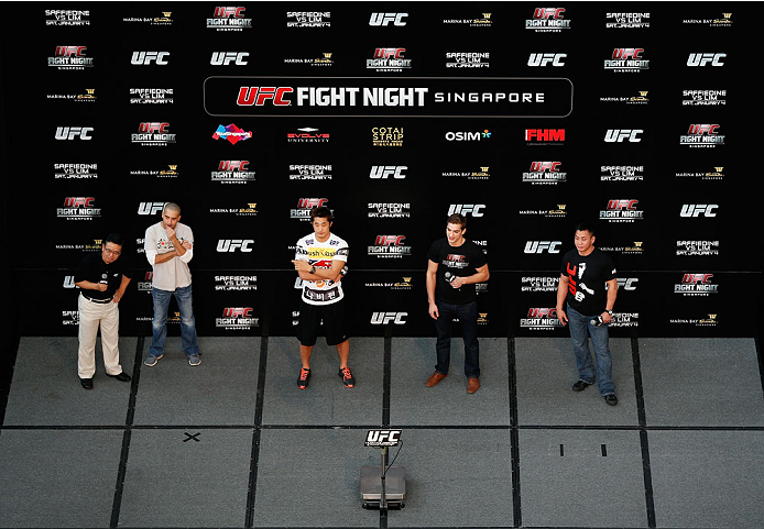 SINGAPORE - JANUARY 03: (R-L) UFC fighters Cung Le, John Hathaway, and Kim Dong Hyun interact with fans during a Q&A session before the UFC Fight Night Singapore Weigh-in at the Shoppes at Marina Bay Sands on January 3, 2014 in Singapore. (Photo by Josh