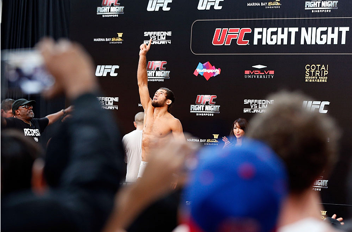 SINGAPORE - JANUARY 03: Fans look on as Mairbek Taisumov weighs in during the UFC Fight Night Singapore Weigh-in at the Shoppes at Marina Bay Sands on January 3, 2014 in Singapore. (Photo by Josh Hedges/Zuffa LLC/Zuffa LLC via Getty Images)