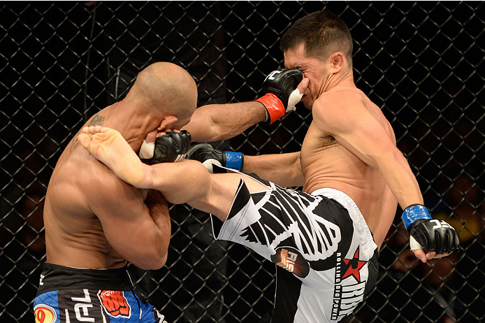 BARUERI, BRAZIL - OCTOBER 9: (L-R) Iliarde Santos punches Chris Cariaso in their flyweight bout during the UFC Fight Night event at the Ginasio Jose Correa on October 9, 2013 in Barueri, Sao Paulo, Brazil. (Photo by Jeff Bottari/Zuffa LLC/Zuffa LLC via G