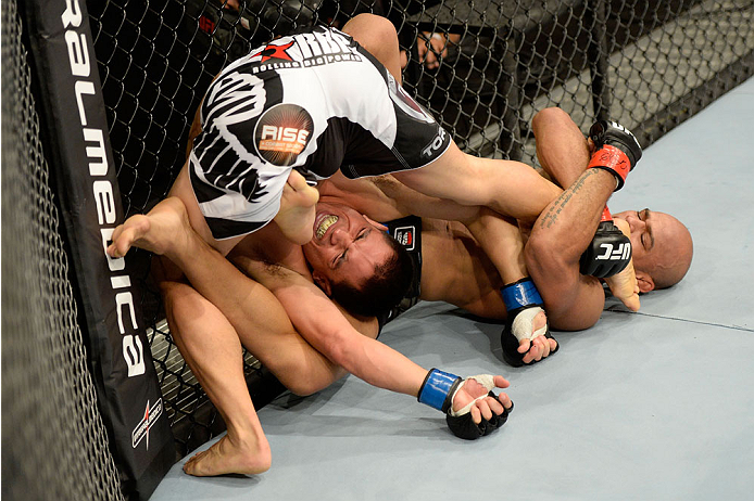 BARUERI, BRAZIL - OCTOBER 9: (R-L) Iliarde Santos attempts a submission against Chris Cariaso in their flyweight bout during the UFC Fight Night event at the Ginasio Jose Correa on October 9, 2013 in Barueri, Sao Paulo, Brazil. (Photo by Jeff Bottari/Zuf