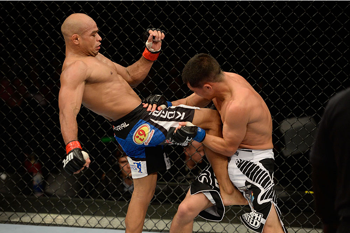 BARUERI, BRAZIL - OCTOBER 9: (L-R) Iliarde Santos lands a knee to the torso of Chris Cariaso in their flyweight bout during the UFC Fight Night event at the Ginasio Jose Correa on October 9, 2013 in Barueri, Sao Paulo, Brazil. (Photo by Jeff Bottari/Zuff