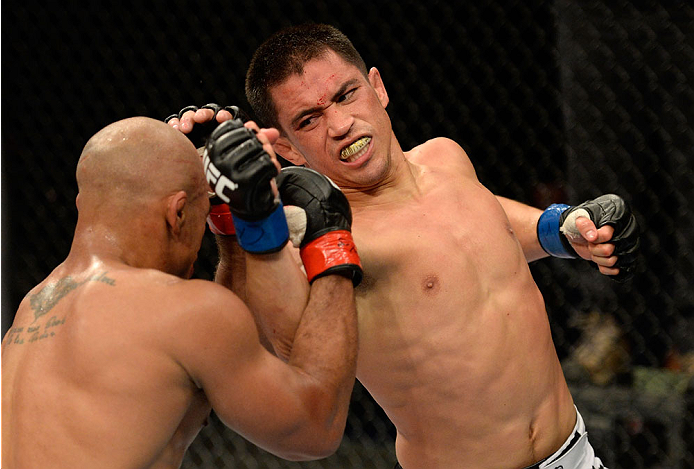 BARUERI, BRAZIL - OCTOBER 9: (R-L) Chris Cariaso punches Iliarde Santos in their flyweight bout during the UFC Fight Night event at the Ginasio Jose Correa on October 9, 2013 in Barueri, Sao Paulo, Brazil. (Photo by Jeff Bottari/Zuffa LLC/Zuffa LLC via G