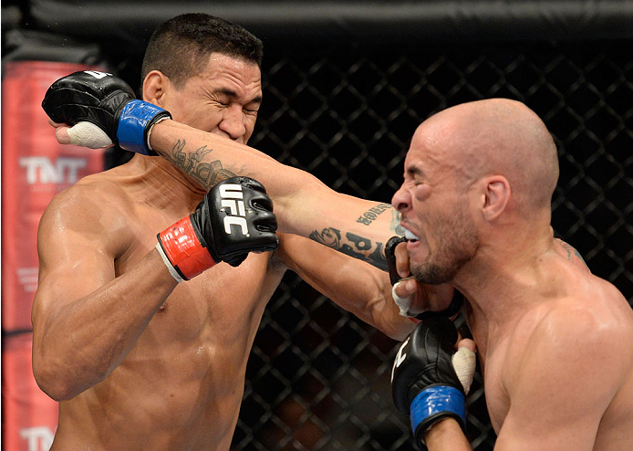 BARUERI, BRAZIL - OCTOBER 9: (R-L) Igor Araujo punches Ildemar Alcantara in their welterweight bout during the UFC Fight Night event at the Ginasio Jose Correa on October 9, 2013 in Barueri, Sao Paulo, Brazil. (Photo by Jeff Bottari/Zuffa LLC/Zuffa LLC v