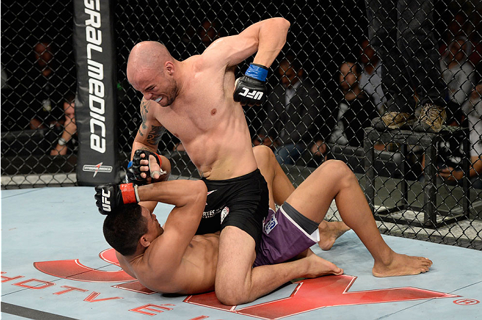 BARUERI, BRAZIL - OCTOBER 9: Igor Araujo (black shorts) punches Ildemar Alcantara in their welterweight bout during the UFC Fight Night event at the Ginasio Jose Correa on October 9, 2013 in Barueri, Sao Paulo, Brazil. (Photo by Jeff Bottari/Zuffa LLC/Zu