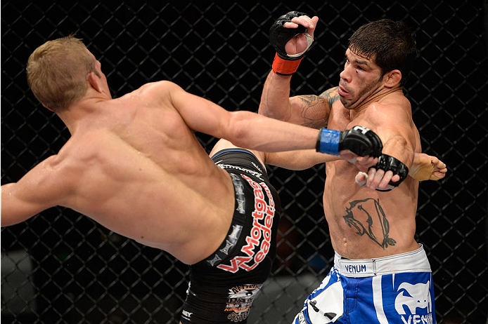 BARUERI, BRAZIL - OCTOBER 9: (L-R) TJ Dillashaw kicks Rafael Assuncao in their bantamweight bout during the UFC Fight Night event at the Ginasio Jose Correa on October 9, 2013 in Barueri, Sao Paulo, Brazil. (Photo by Jeff Bottari/Zuffa LLC/Zuffa LLC via