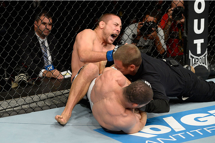 BARUERI, BRAZIL - OCTOBER 9: (L-R) Mike Pierce screams while getting submitted by Rousimar Palhares in their welterweight bout during the UFC Fight Night event at the Ginasio Jose Correa on October 9, 2013 in Barueri, Sao Paulo, Brazil. (Photo by Jeff Bo