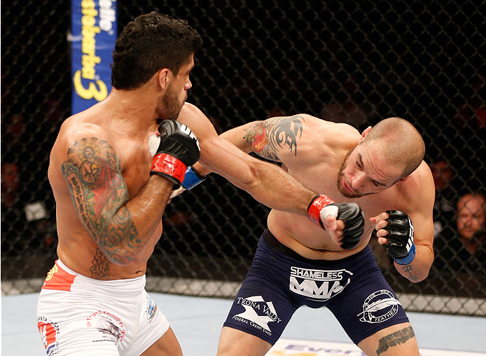 GOIANIA, BRAZIL - NOVEMBER 09: (L-R) Thiago Tavares punches Justin Salas in their lightweight bout during the UFC event at Arena Goiania on November 9, 2013 in Goiania, Brazil. (Photo by Josh Hedges/Zuffa LLC/Zuffa LLC via Getty Images)