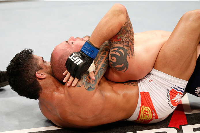 GOIANIA, BRAZIL - NOVEMBER 09: (L-R) Thiago Tavares secures a rear choke submission against Justin Salas in their lightweight bout during the UFC event at Arena Goiania on November 9, 2013 in Goiania, Brazil. (Photo by Josh Hedges/Zuffa LLC/Zuffa LLC via
