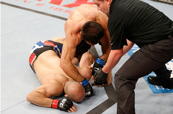 GOIANIA, BRAZIL - NOVEMBER 09: (R-L) Omari Akhmedov knocks out Thiago Perpetuo with a punch in their middleweight bout during the UFC event at Arena Goiania on November 9, 2013 in Goiania, Brazil. (Photo by Josh Hedges/Zuffa LLC/Zuffa LLC via Getty Images