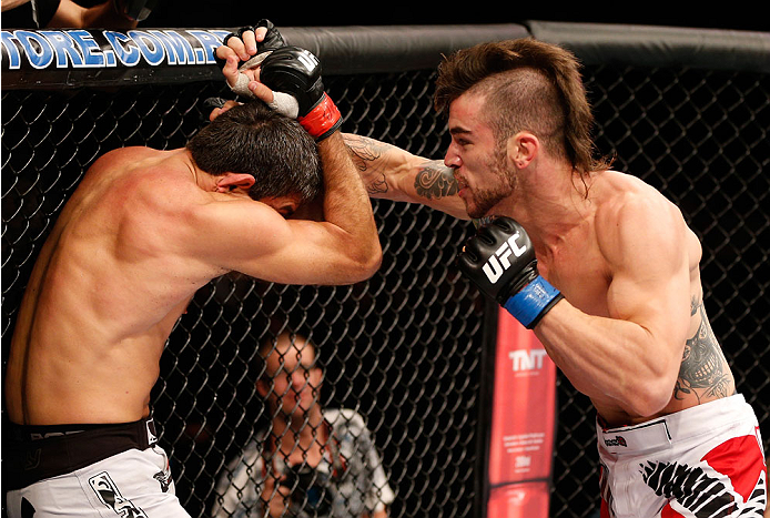 GOIANIA, BRAZIL - NOVEMBER 09: (R-L) Brandon Thatch punches Paulo Thiago in their welterweight bout during the UFC event at Arena Goiania on November 9, 2013 in Goiania, Brazil. (Photo by Josh Hedges/Zuffa LLC/Zuffa LLC via Getty Images)