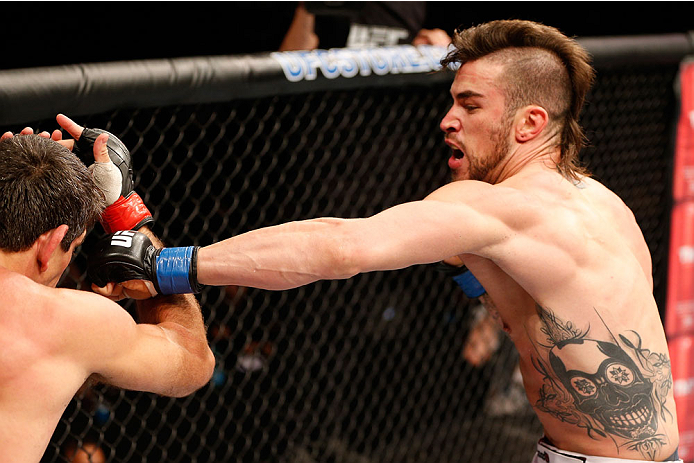 GOIANIA, BRAZIL - NOVEMBER 09: (R-L) Brandon Thatch punches Paulo Thiago in their welterweight bout during the UFC event at Arena Goiania on November 9, 2013 in Goiania, Brazil. (Photo by Josh Hedges/Zuffa LLC/Zuffa LLC via Getty Images)