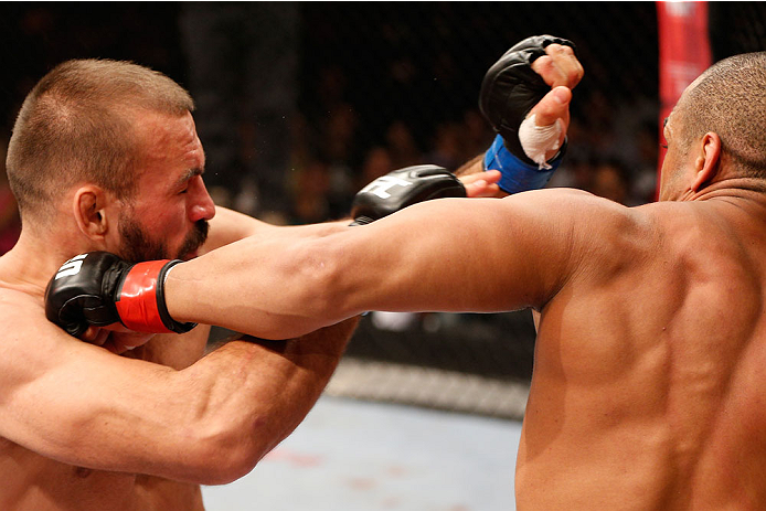 GOIANIA, BRAZIL - NOVEMBER 09: (R-L) Rafael ''Fejao'' Cavalcante punches Igor Pokrajac in their light heavyweight bout during the UFC event at Arena Goiania on November 9, 2013 in Goiania, Brazil. (Photo by Josh Hedges/Zuffa LLC/Zuffa LLC via Getty Images