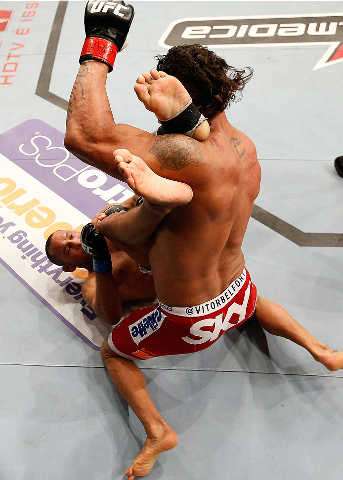 GOIANIA, BRAZIL - NOVEMBER 09: (R-L) Vitor Belfort punches Dan Henderson in their light heavyweight bout during the UFC event at Arena Goiania on November 9, 2013 in Goiania, Brazil. (Photo by Josh Hedges/Zuffa LLC/Zuffa LLC via Getty Images)