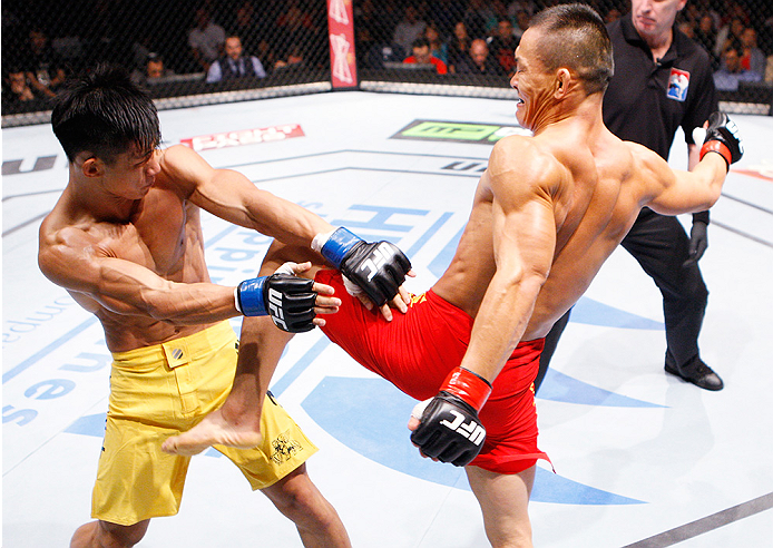MACAU - AUGUST 23: Ning Guangyou throws a knee at Yang Jianping in their featherweight fight during the UFC Fight Night event at the Venetian Macau on August 23, 2014 in Macau. (Photo by Mitch Viquez/Zuffa LLC/Zuffa LLC via Getty Images)