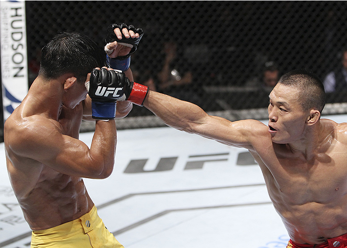 MACAU - AUGUST 23: Ning Guangyou punches Yang Jianping in their featherweight fight during the UFC Fight Night event at the Venetian Macau on August 23, 2014 in Macau. (Photo by Mitch Viquez/Zuffa LLC/Zuffa LLC via Getty Images)