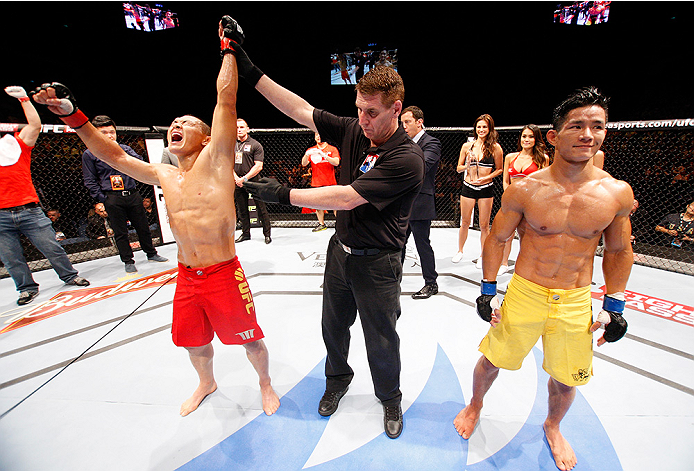 MACAU - AUGUST 23: Ning Guangyou celebrates after defeating Yang Jianping in their featherweight fight during the UFC Fight Night event at the Venetian Macau on August 23, 2014 in Macau. (Photo by Mitch Viquez/Zuffa LLC/Zuffa LLC via Getty Images)