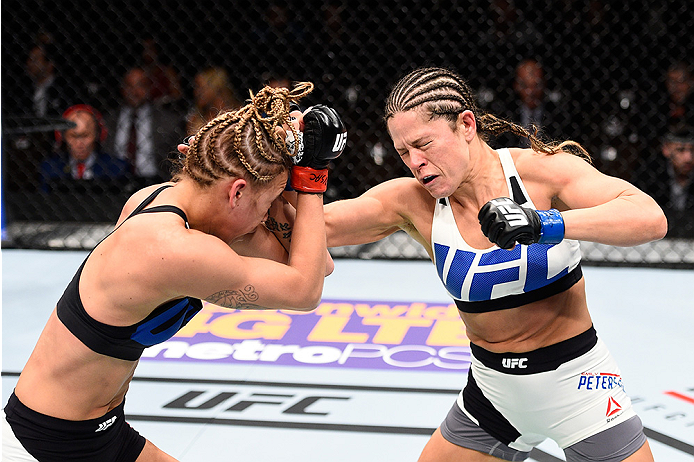 LAS VEGAS, NEVADA - DECEMBER 10: (R) Emily Kagan punches Kailan Curran in their women's strawweight bout during the UFC Fight Night event at The Chelsea at the Cosmopolitan of Las Vegas on December 10, 2015 in Las Vegas, Nevada. (Photo by Jeff Bottari/Z