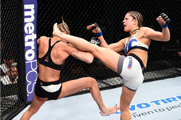 LAS VEGAS, NEVADA - DECEMBER 10: (R) Emily Kagan kicks Kailan Curran in their women's strawweight bout during the UFC Fight Night event at The Chelsea at the Cosmopolitan of Las Vegas on December 10, 2015 in Las Vegas, Nevada. (Photo by Jeff Bottari/Zuf