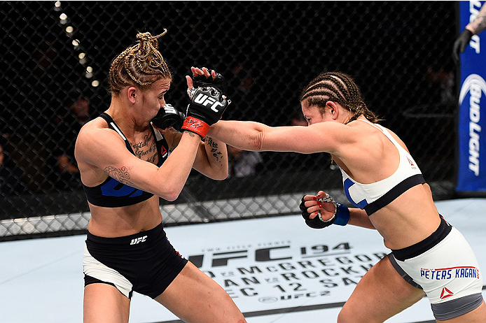 LAS VEGAS, NEVADA - DECEMBER 10: (R) Emily Kagan punches Kailan Curran in their women's strawweight bout during the UFC Fight Night event at The Chelsea at the Cosmopolitan of Las Vegas on December 10, 2015 in Las Vegas, Nevada. (Photo by Jeff Bottari/Zu
