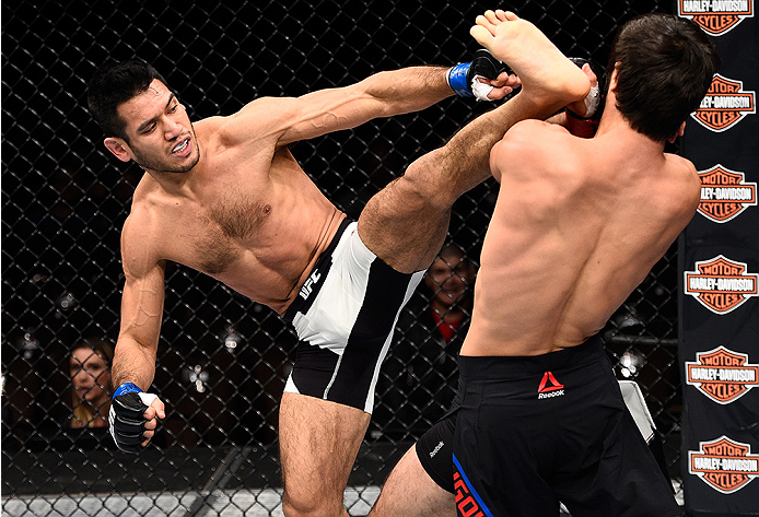 LAS VEGAS, NEVADA - DECEMBER 10: (L) Phillipe Nover kicks Zubaira Tukhugov in their featherweight bout during the UFC Fight Night event at The Chelsea at the Cosmopolitan of Las Vegas on December 10, 2015 in Las Vegas, Nevada. (Photo by Jeff Bottari/Zuf