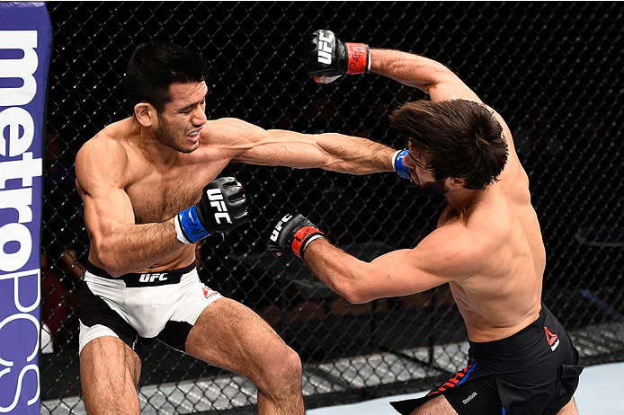 LAS VEGAS, NEVADA - DECEMBER 10: (L) Phillipe Nover punches Zubaira Tukhugov in their featherweight bout during the UFC Fight Night event at The Chelsea at the Cosmopolitan of Las Vegas on December 10, 2015 in Las Vegas, Nevada. (Photo by Jeff Bottari/Zu