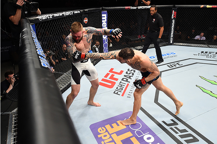 LAS VEGAS, NEVADA - DECEMBER 10: (R) Santiago Ponzinibbio punches Andreas Stahl in their welterweight bout during the UFC Fight Night event at The Chelsea at the Cosmopolitan of Las Vegas on December 10, 2015 in Las Vegas, Nevada. (Photo by Jeff Bottari