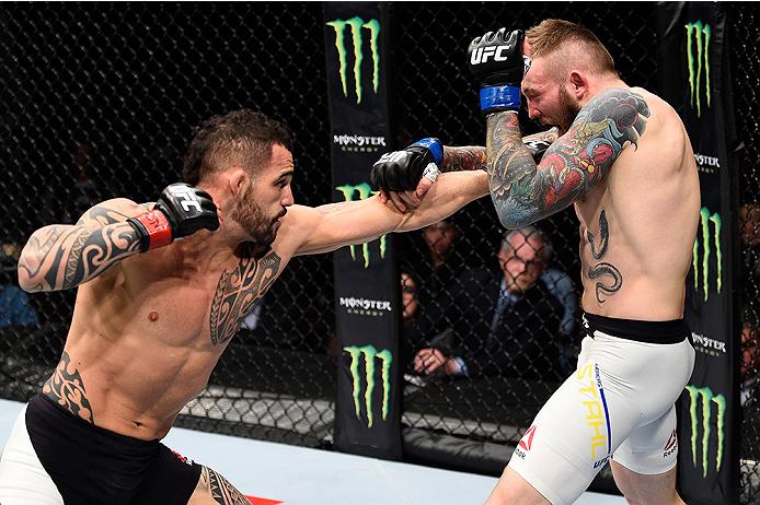 LAS VEGAS, NEVADA - DECEMBER 10: (L) Santiago Ponzinibbio punches Andreas Stahl in their welterweight bout during the UFC Fight Night event at The Chelsea at the Cosmopolitan of Las Vegas on December 10, 2015 in Las Vegas, Nevada. (Photo by Jeff Bottari