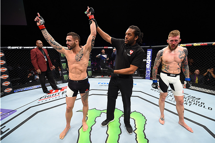 LAS VEGAS, NEVADA - DECEMBER 10: (L) Santiago Ponzinibbio celebrates his win over Andreas Stahl in their welterweight bout during the UFC Fight Night event at The Chelsea at the Cosmopolitan of Las Vegas on December 10, 2015 in Las Vegas, Nevada. (Photo
