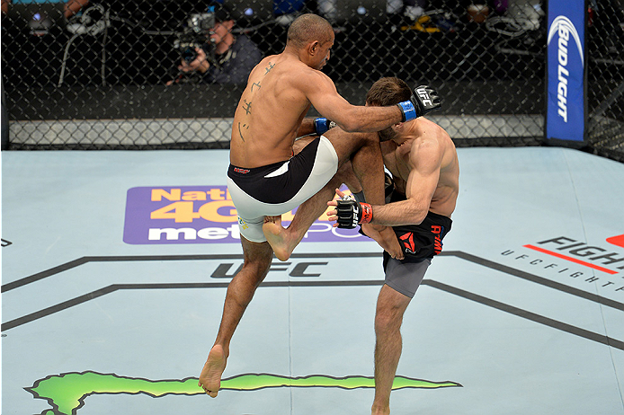 LAS VEGAS, NEVADA - DECEMBER 10: (L) Sergio Moraes knees Omari Akhmedov in their welterweight bout during the UFC Fight Night event at The Chelsea at the Cosmopolitan of Las Vegas on December 10, 2015 in Las Vegas, Nevada. (Photo by Brandon Magnus/Zuffa