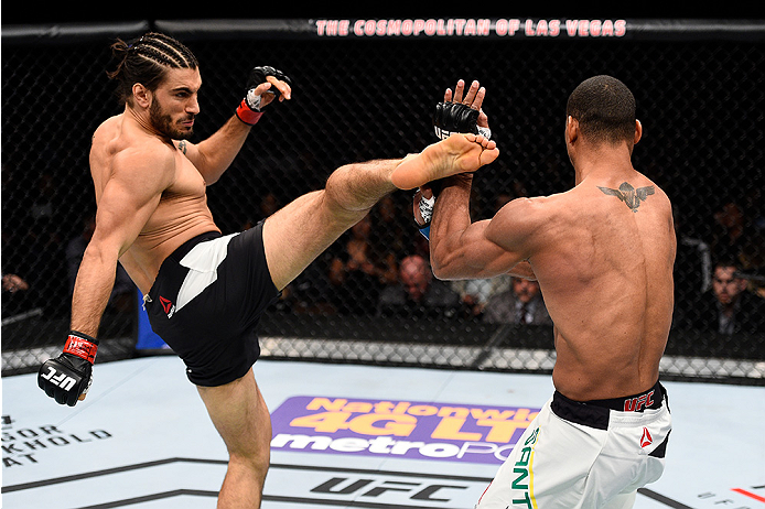 LAS VEGAS, NEVADA - DECEMBER 10: (L) Elias Theodorou kicks Thiago Santos in their middleweight bout during the UFC Fight Night event at The Chelsea at the Cosmopolitan of Las Vegas on December 10, 2015 in Las Vegas, Nevada. (Photo by Jeff Bottari/Zuffa