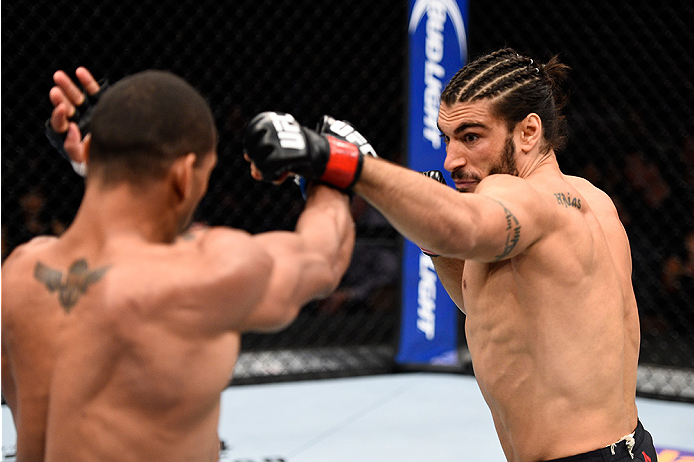 LAS VEGAS, NEVADA - DECEMBER 10: (R) Elias Theodorou punches Thiago Santos in their middleweight bout during the UFC Fight Night event at The Chelsea at the Cosmopolitan of Las Vegas on December 10, 2015 in Las Vegas, Nevada. (Photo by Jeff Bottari/Zuff