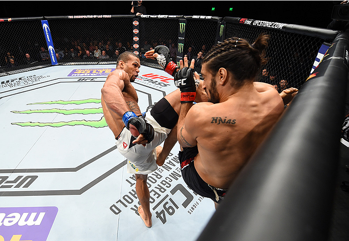 LAS VEGAS, NEVADA - DECEMBER 10: (L) Thiago Santos kicks Elias Theodorou in their middleweight bout during the UFC Fight Night event at The Chelsea at the Cosmopolitan of Las Vegas on December 10, 2015 in Las Vegas, Nevada. (Photo by Jeff Bottari/Zuffa