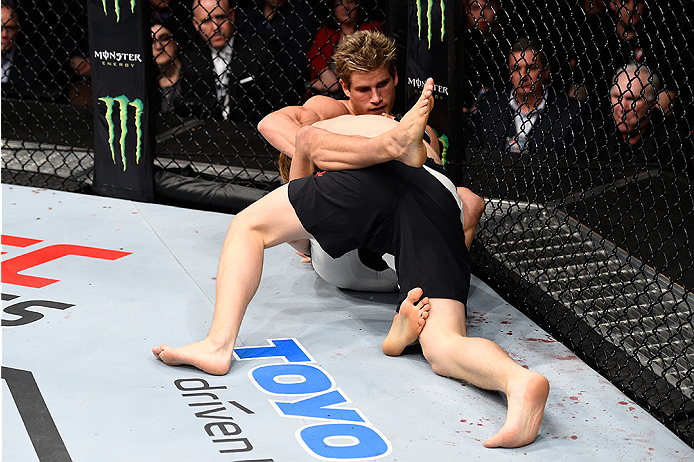 LAS VEGAS, NEVADA - DECEMBER 10: (Top) Sage Northcutt grapples with Cody Pfister in their lightweight bout during the UFC Fight Night event at The Chelsea at the Cosmopolitan of Las Vegas on December 10, 2015 in Las Vegas, Nevada. (Photo by Jeff Bottari