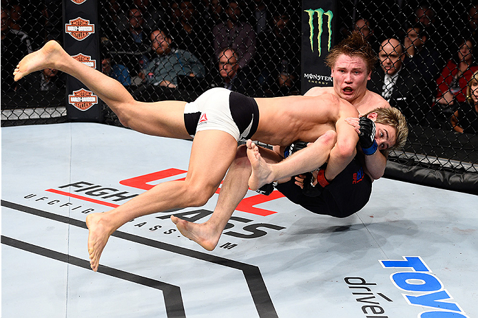 LAS VEGAS, NEVADA - DECEMBER 10: (Bottom) Sage Northcutt takes down Cody Pfister in their lightweight bout during the UFC Fight Night event at The Chelsea at the Cosmopolitan of Las Vegas on December 10, 2015 in Las Vegas, Nevada. (Photo by Jeff Bottari