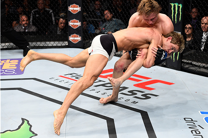 LAS VEGAS, NEVADA - DECEMBER 10: (Bottom) Sage Northcutt takes down Cody Pfister in their lightweight bout during the UFC Fight Night event at The Chelsea at the Cosmopolitan of Las Vegas on December 10, 2015 in Las Vegas, Nevada. (Photo by Jeff Bottari