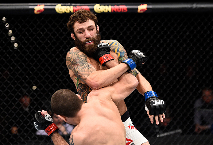 LAS VEGAS, NEVADA - DECEMBER 10: (Bottom) Jim Miller punches Michael Chiesa in their lightweight bout during the UFC Fight Night event at The Chelsea at the Cosmopolitan of Las Vegas on December 10, 2015 in Las Vegas, Nevada. (Photo by Jeff Bottari/Zuff